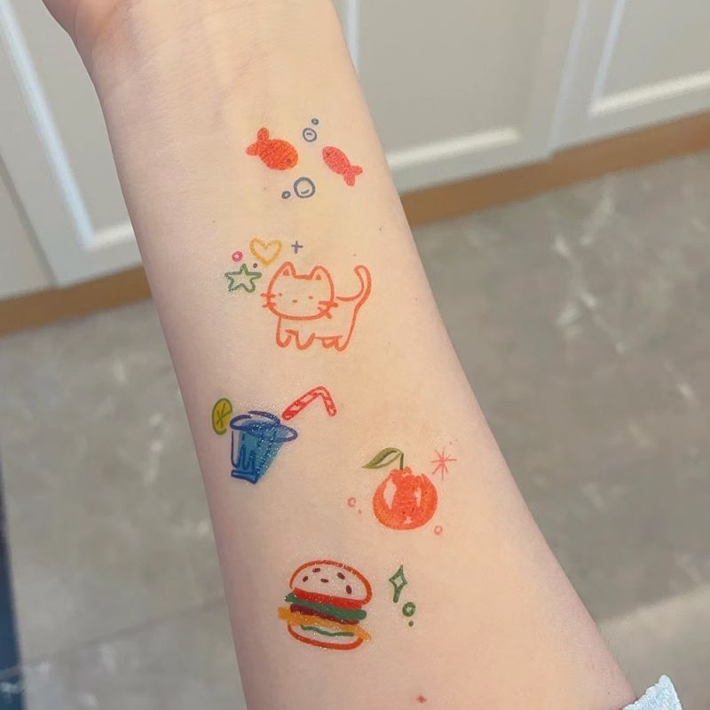 Summer-themed temporary tattoo sticker collection – 25×20mm colourful illustrations including animals, beach elements, food, and celestial icons by TIDES.